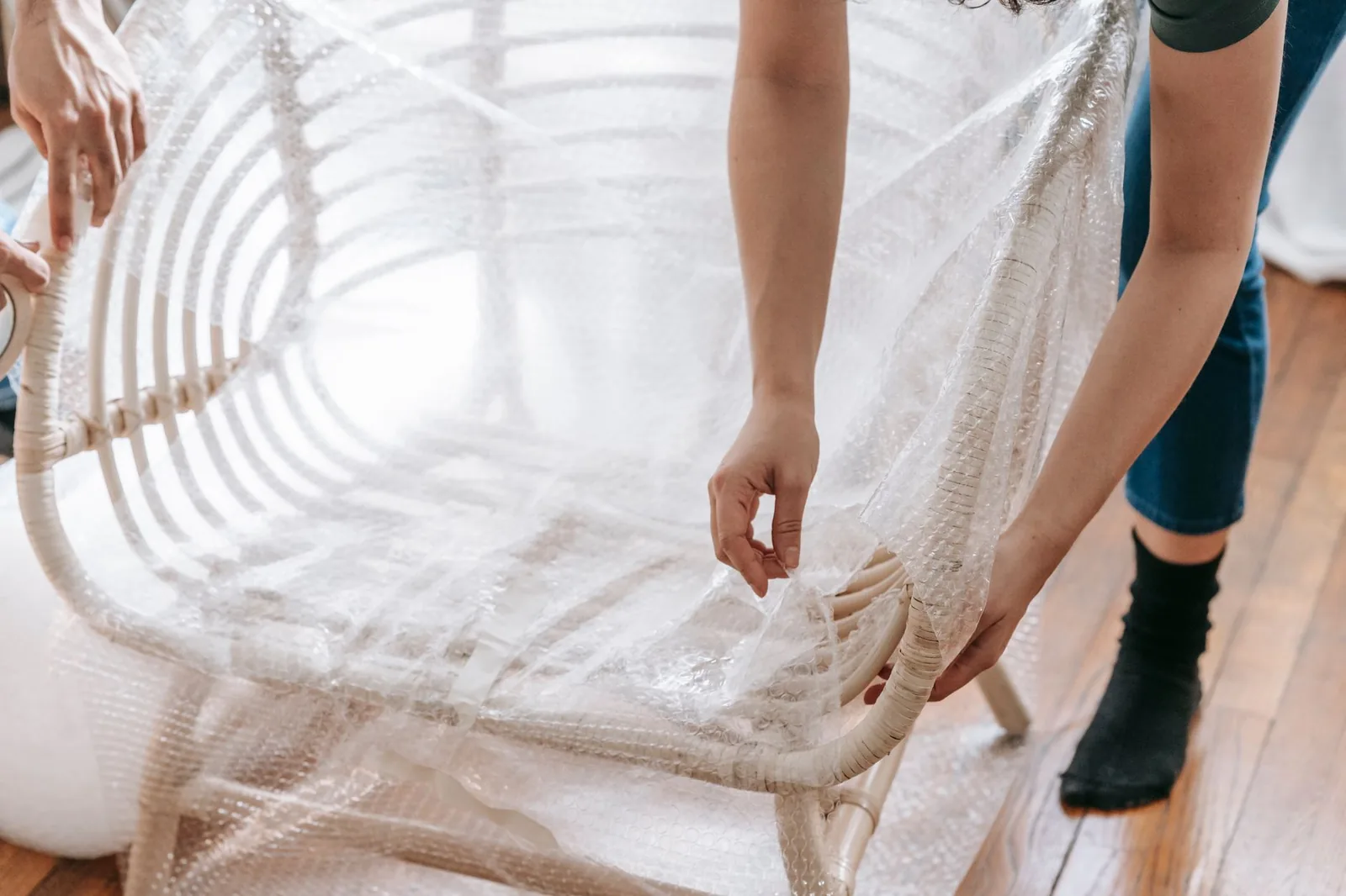 A wooden chair wrapped in bubble wrap before going into storage